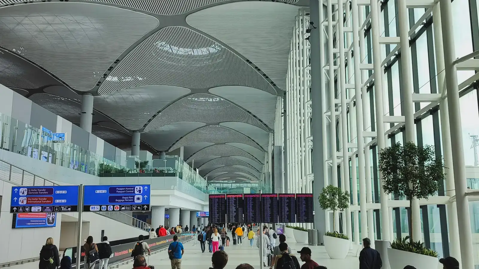 Travelers walking through a bright modern international airport terminal